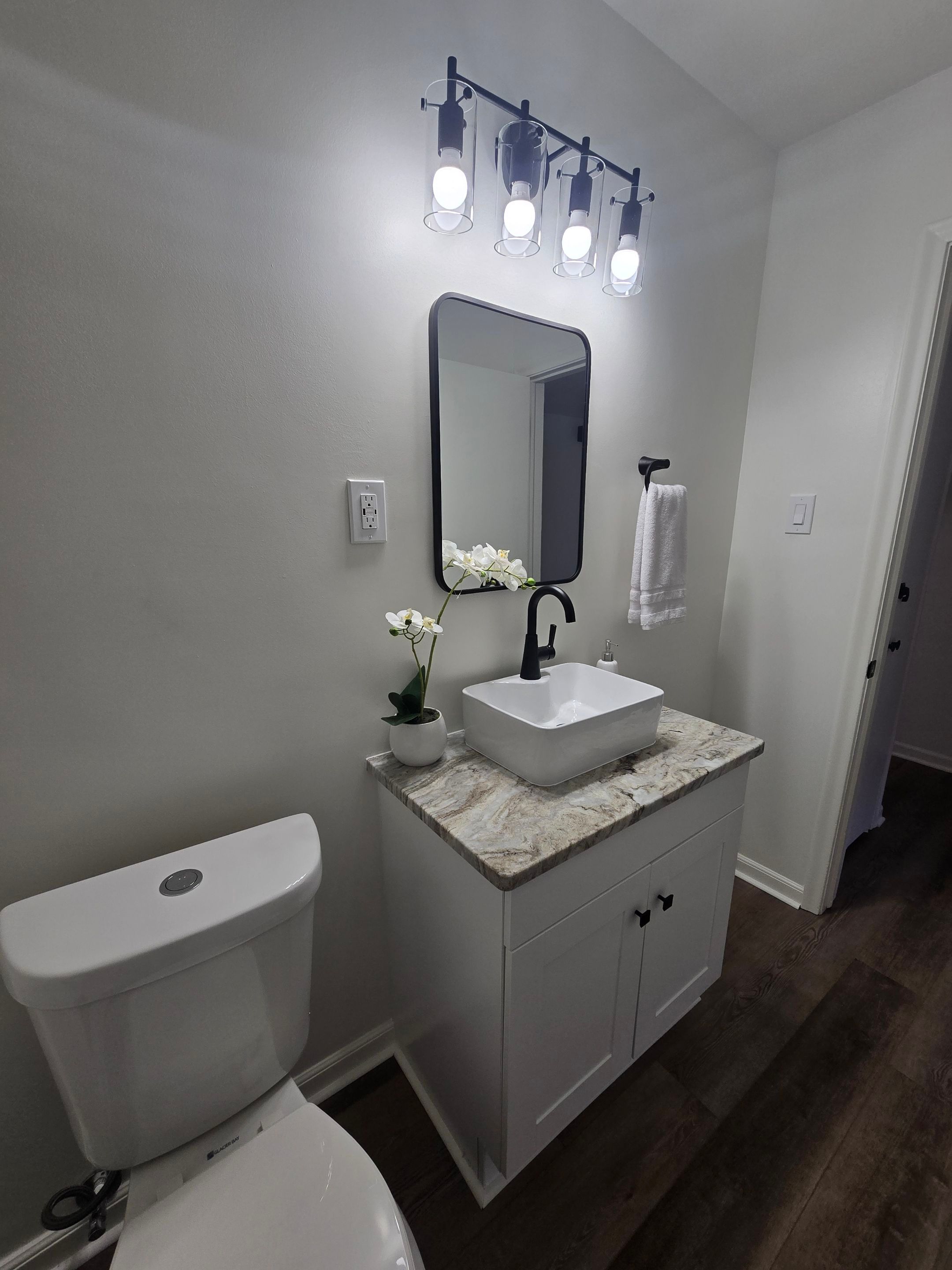Finished bathroom vanity and lighting in a residential renovation
