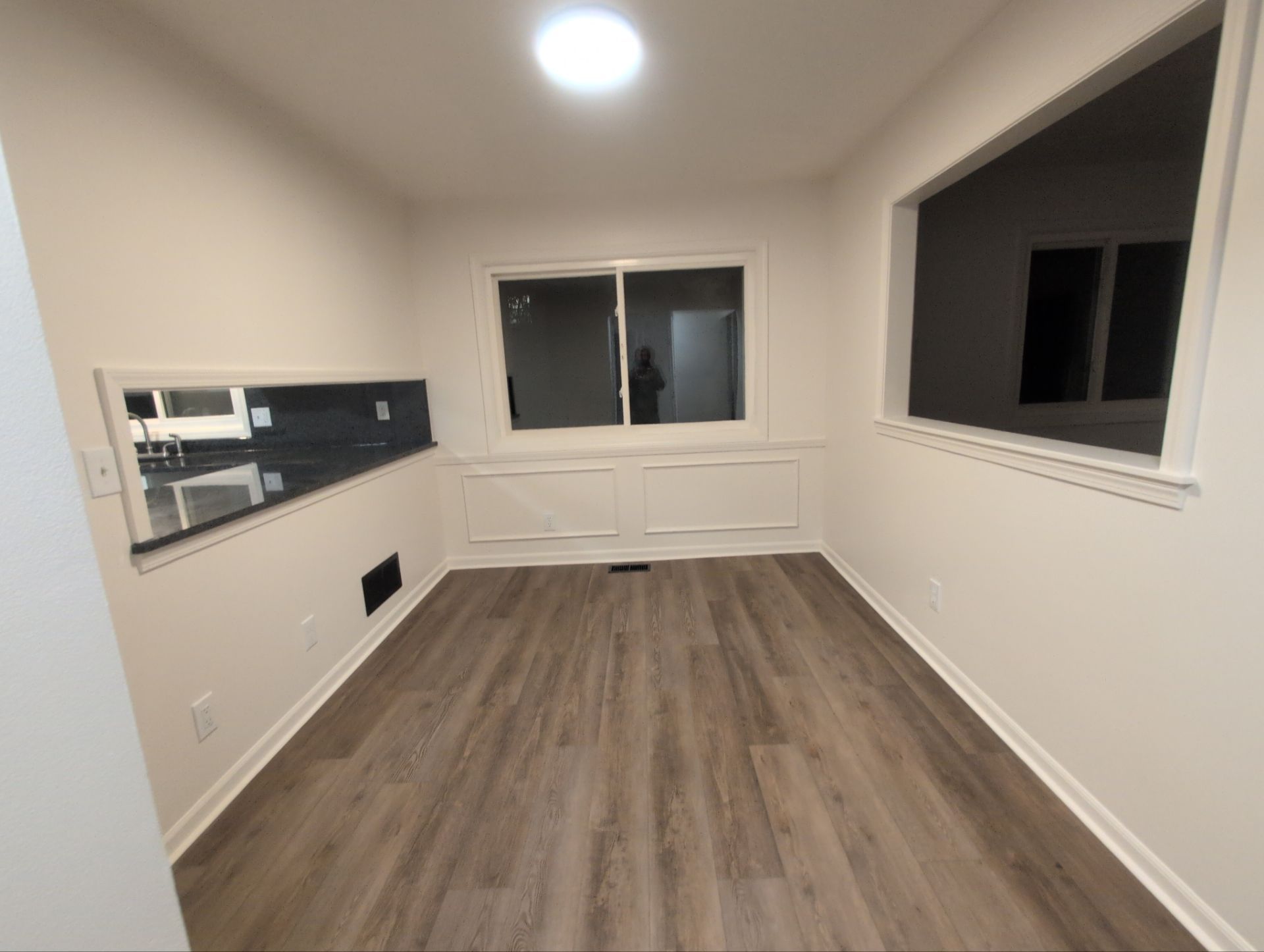 Finished adjoining residential interior with updated flooring and paint