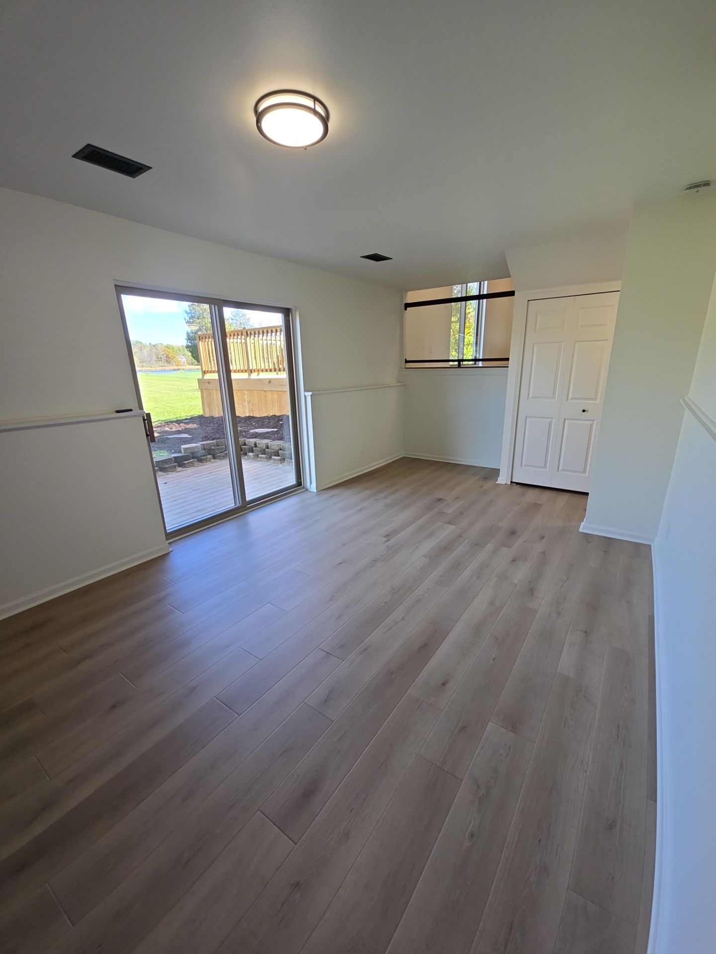 Finished residential room with updated flooring, walls, and trim