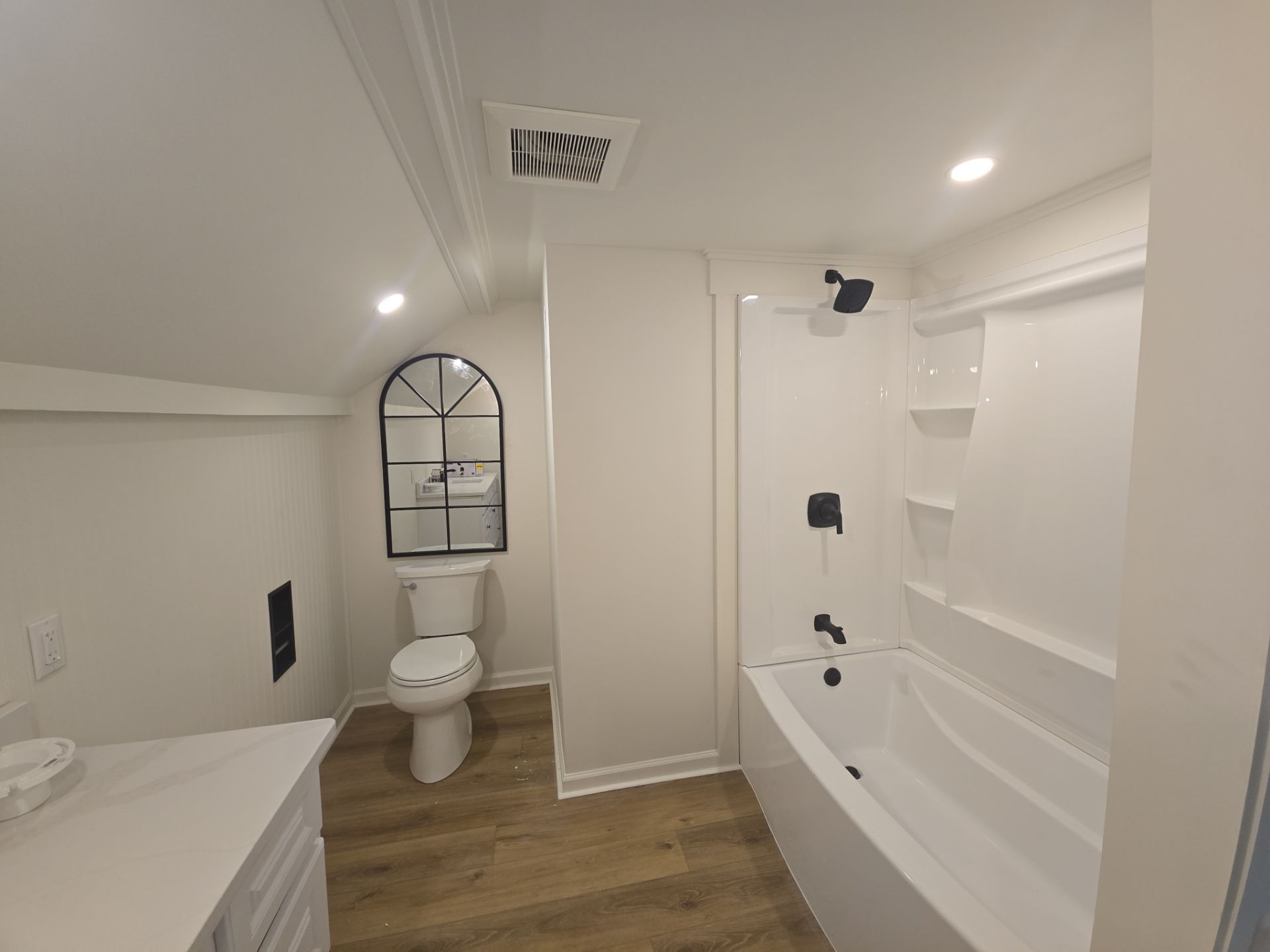 Finished residential bathroom with updated fixtures and flooring